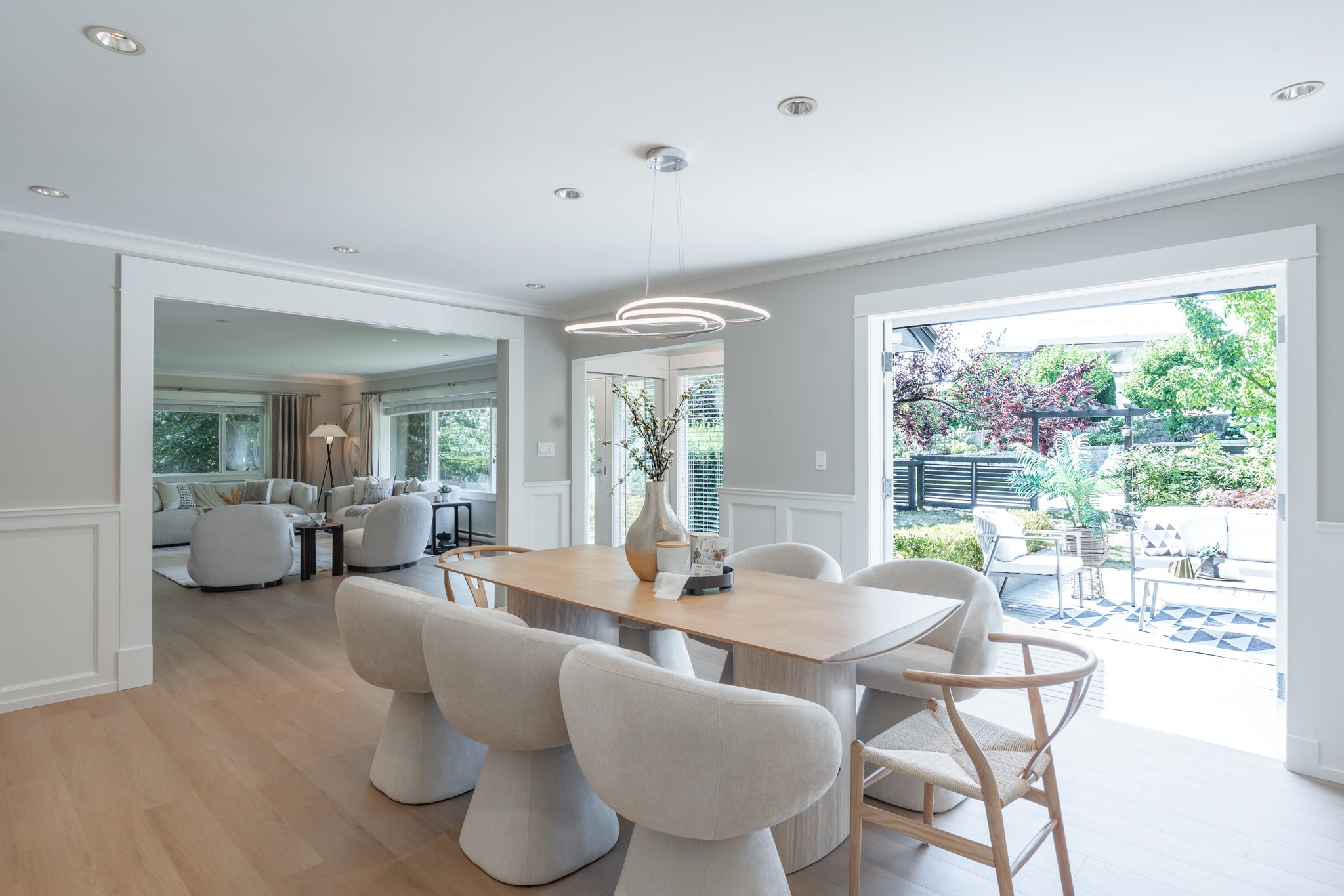 Elegant dining area with wide doors opening onto the backyard patio
