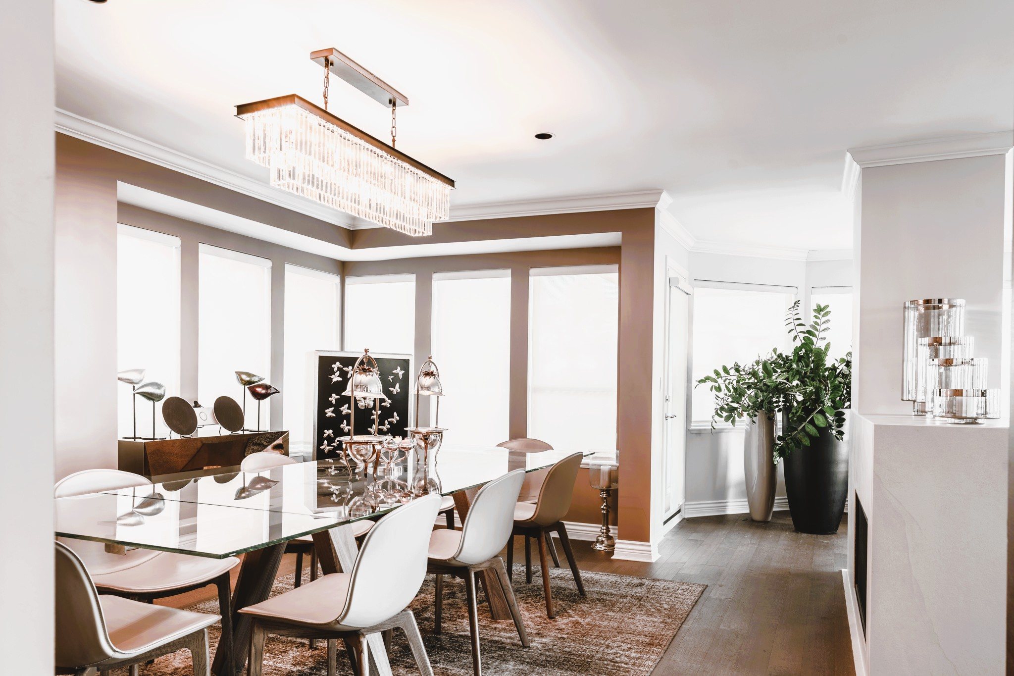 Bright formal dining room with chandelier and large windows