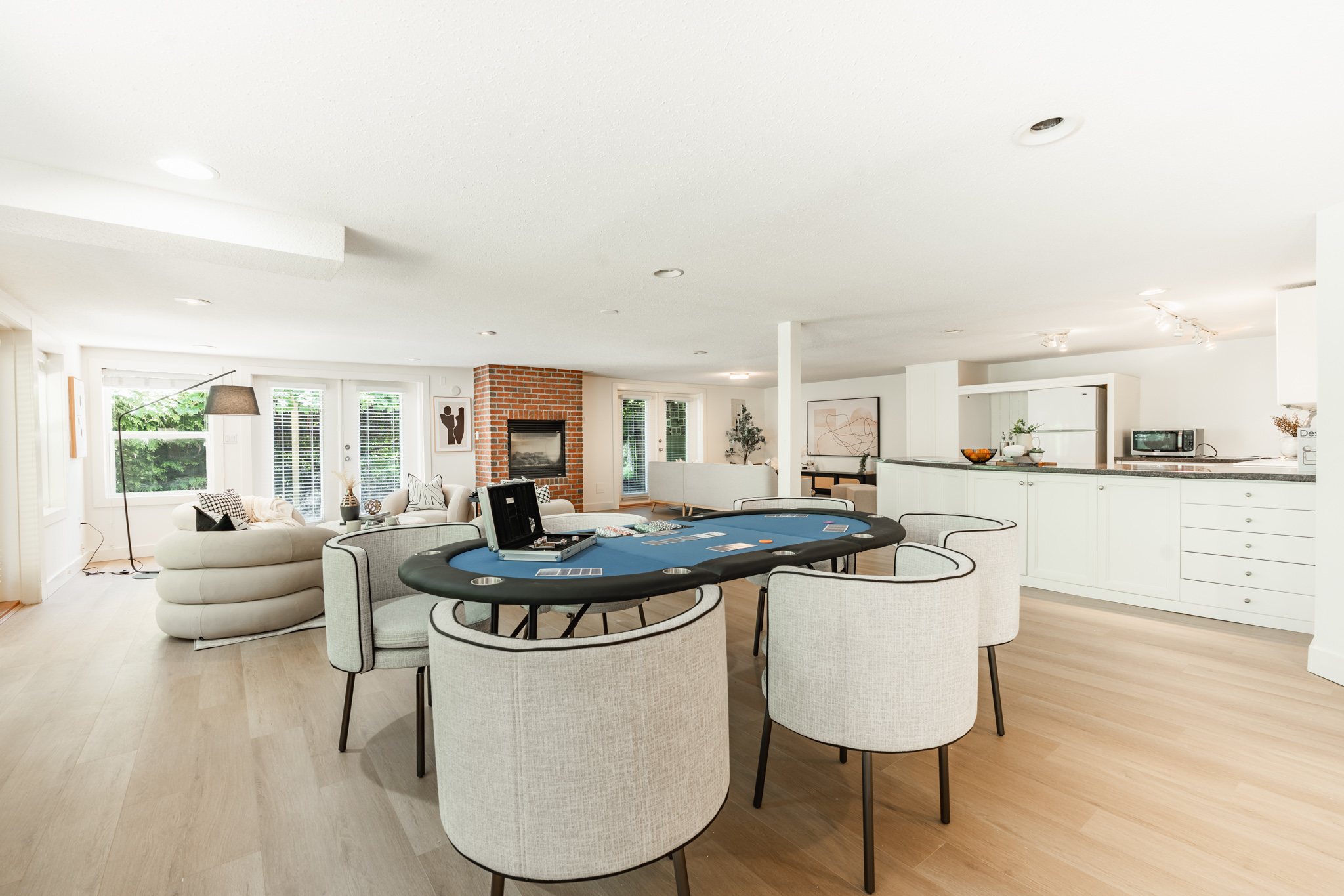 Spacious entertainment area with games table, lounge seating, and built-in bar